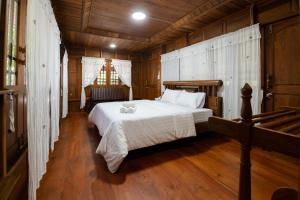 Postel nebo postele na pokoji v ubytování Suk Sabai Homestay