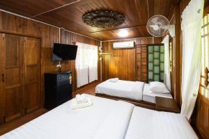 Postel nebo postele na pokoji v ubytování Suk Sabai Homestay