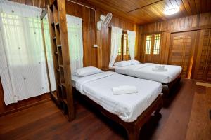 Postel nebo postele na pokoji v ubytování Suk Sabai Homestay
