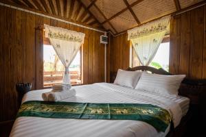 Postel nebo postele na pokoji v ubytování Suk Sabai Homestay