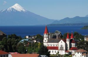 a town with a church and a mountain in the background at Departamento 2d1b Puerto Varas in Puerto Varas