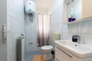 a white bathroom with a toilet and a sink at Apartments Sabina in Supetarska Draga +48 photos