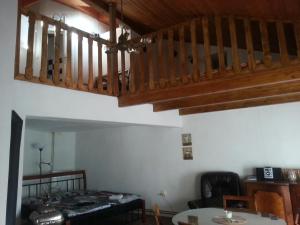 a living room with a staircase and a table at Penzion U Tomáše in Jindřichŭv Hradec