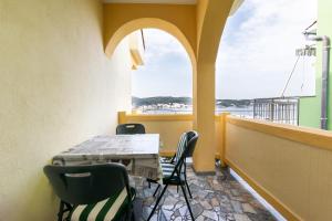a balcony with a table and chairs and a window at Apartments Sabina in Supetarska Draga