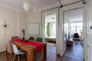 a dining room with a table and a bedroom at Soft & Historic 3BR Home w/ Iconic Haydarpaşa View in Istanbul