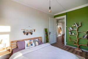 a bedroom with a bed and a green wall at Soft & Historic 3BR Home w/ Iconic Haydarpaşa View in Istanbul