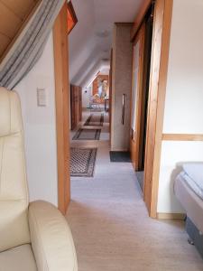 a hallway in a house with a couch and chairs at Haus mit Seele im Nahetal in Weinsheim