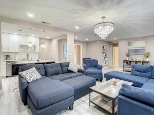 a living room with a blue couch and blue chairs at AMI, IMG, Beach, Bikes, Golf, Hottub, Fish, Beach, BBQ, SRQ in Bradenton
