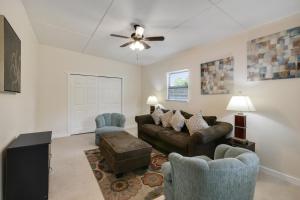 a living room with a couch and two chairs at 3 bedroom House with Renovated kitchen and bath! in Cocoa