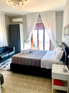 a bedroom with a large bed and a balcony at Spacious apartment in Taormina with sea view and balconies in Taormina