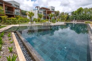 an image of a swimming pool at a resort at Prestigious waterfront apartment with huge pool! in Pointe aux Piments