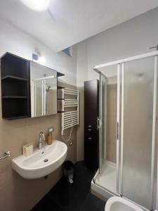 a bathroom with a sink and a shower at Bocconi Apartment in Milan
