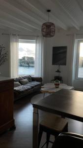 a living room with a couch and a table at Villa Sainte-Anne - Ploemeur in Ploemeur