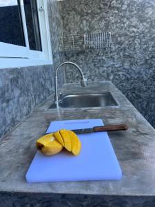 a banana sitting on a cutting board next to a knife at PP Pool Villa Maesalong Chiangrai in Mae Salong Nai