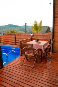 a table and chairs on a deck next to a pool at Irmak Vadi Bungalov Zonguldak 
