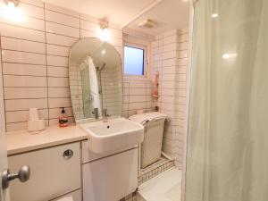 a bathroom with a sink and a mirror and a shower at Wood Cottage in Kendal +10 photos