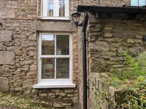 a stone building with a window on it at Wood Cottage in Kendal