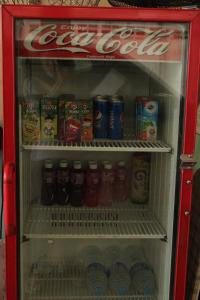 a cocacola refrigerator filled with drinks and soda at Saeng Chan Apartment in Hat Yai