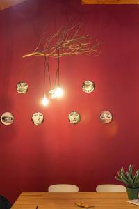 a red wall with a bunch of clocks on it at LE MUSE Comano Terme Holiday 2, primo piano in Comano Terme