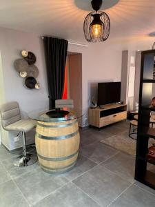 a living room with a wine barrel and a table at Love Room Cocooning & Spa in Épinal