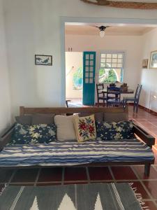 a couch in a living room with pillows on it at Casa Dos Arcos Bed and Breakfast in Arraial do Cabo