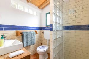 a bathroom with a toilet and a sink at Da Casa Sesta in Sagres +29 photos