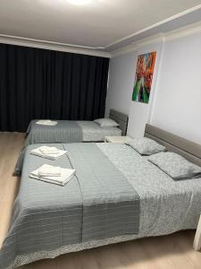a bedroom with two beds with towels on them at Şehir Merkezinde Daire in Antalya