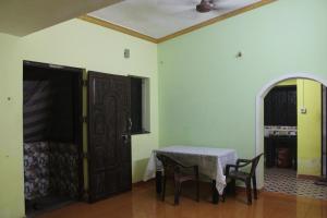 a room with a table and chairs and a door at Affordable and Cheapest stay in North Goa - 1BHK in Colovale