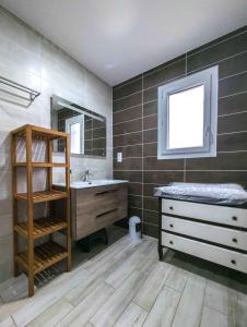a bathroom with a sink and a mirror at La cabane in Vias