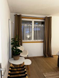 a room with a table and two chairs and a window at Appartement Les Salines in Roche