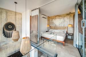 a bedroom with a bed and a glass balcony at Tulum Paradise - Penthouse with Private Pool and Cenote in Tulum +29 photos