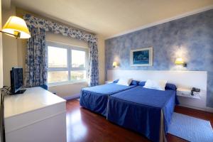 Postel nebo postele na pokoji v ubytování Hotel Guadalquivir