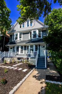 a large blue house with a porch and stairs at Comfy Micro Apartment 1BR 1 Bath close to the falls in Niagara Falls
