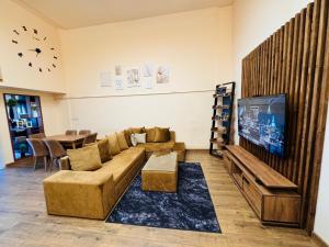 a living room with a couch and a flat screen tv at Arshakunyats 88 TopHouse in Yerevan