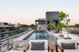 a swimming pool on the roof of a house at Tulum Paradise - Penthouse with Private Pool and Cenote in Tulum