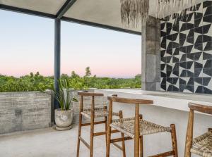 a patio with chairs and a bar with a view at Tulum Paradise - Penthouse with Private Pool and Cenote in Tulum