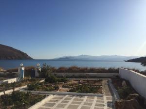 a garden with a view of the water at Sunrise view house in Molos Parou