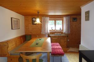 a dining room with a wooden table and chairs at Mathehanshütte in Innerkrems