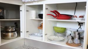 a white cabinet with dishes and utensils in it at Casa rural en Finca Don Amado, San Mateo in Las Palmas de Gran Canaria