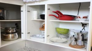 a white cabinet with dishes and utensils in it at Casa rural en San Mateo in Las Palmas de Gran Canaria