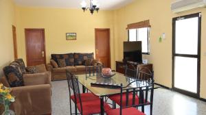a living room with a table and chairs at Casa rural Finca Don Amado, San Mateo in Las Palmas de Gran Canaria