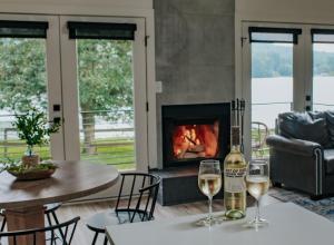 two glasses of wine on a table with a fireplace at Tranquille Resort in Hiawassee
