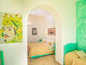 a room with two beds and a painting on the wall at Hotel Ossidiana Stromboli Center in Stromboli