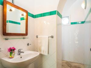 a bathroom with a sink and a mirror at Hotel Ossidiana Stromboli Center in Stromboli