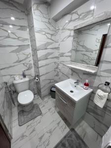 a bathroom with a toilet and a sink at Kenitra Unique Design Appartment in Kenitra