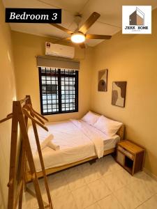 a bedroom with a bed with a window and a ladder at JEKK Home - Homestay KT in Kuala Terengganu +15 photos