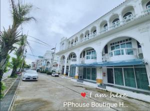 a building with a car parked in front of it at PPhouse Boutique House Phuket Town in Ban Bang Khu