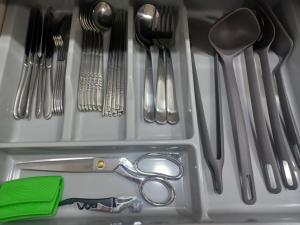 a plastic drawer with utensils and a pair of scissors at All In One Guesthouse in Incheon