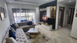 a living room with a couch and a fireplace at Superbe Appartement Meublé in Mohammedia