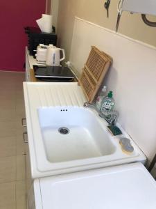 a kitchen with a sink in a small kitchen at Grand studio avec petite vue mer in Mers-les-Bains